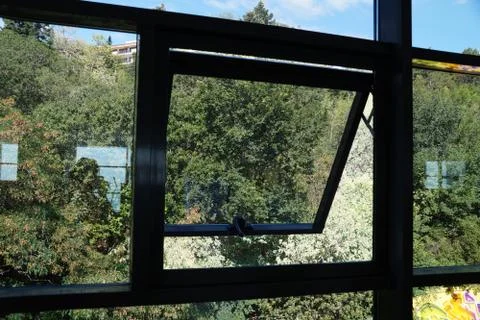 Open small window in a large plastic window Stock Photos