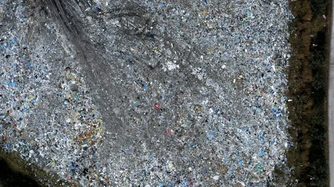 Open solid waste dump and small bulldozer, Pollution from waste Stock Footage 106981461