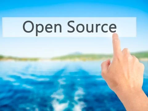 Open Source - Hand pressing a button on blurred background concept on visual  Stock Photos