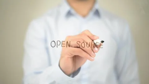 Open Source , Man writing on transparent screen Foto stock