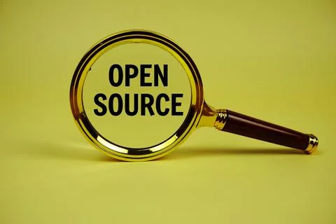 Open Source text with magnifying glass on yellow background Stock Photos