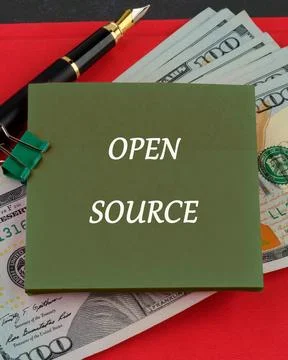 OPEN SOURCE words written on a sticker on the background of dollar bills Foto stock