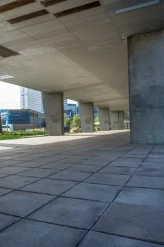 Open space on the base of the skyscraper building with a maintenance openings Stock Photos