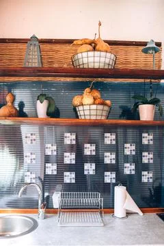 Open space kitchen interior. Sink and shelves with fruits. Rustic style kitch Foto stock