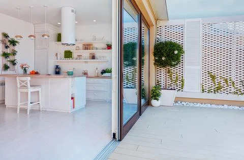 Open space kitchen with sliding doors and rooftop patio zone Stock Photos