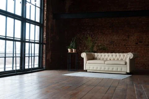 Open space loft interior with big windows filled with sunlight Stock Photos