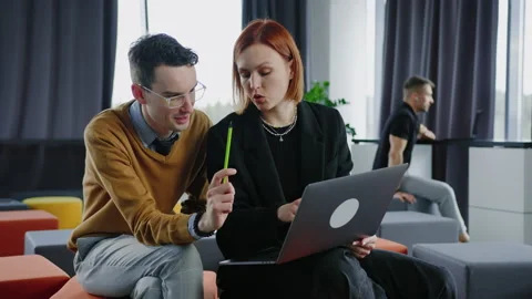 An open space for working in the office. Colleagues are discussing a new project Stock Footage 232476285