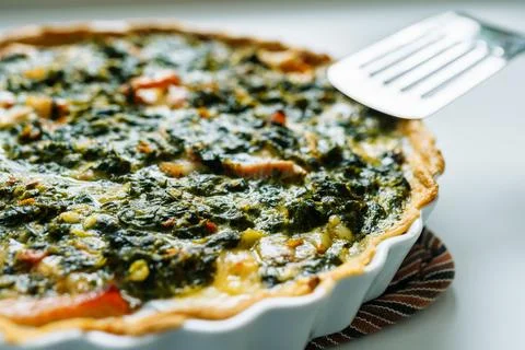 Open spinach pie in baking dish Stock Photos