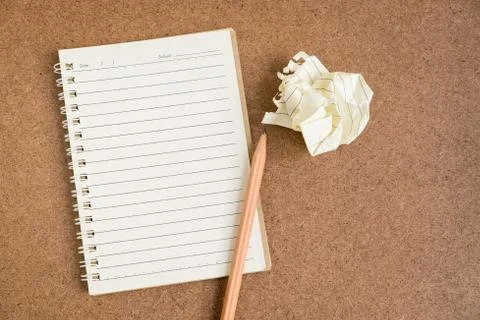 Open spiral notebook on brown background Stock Photos