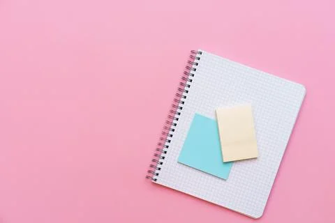 An open spiral notepad with stickers lying on top. Stationery Stock Photos