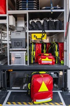 Open storage compartments inside an ambulance containing medical equipment,.. Фото
