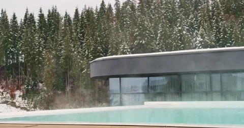 Open swimming pool at ski mountain resort during day. Stock Footage 238079650