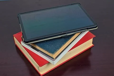 Open Tablet on Top of Books Stock Photos