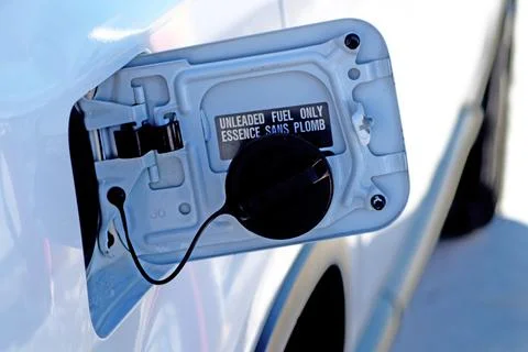 An open tank of a car while refueling with gasoline in the frosty winter time Stock Photos