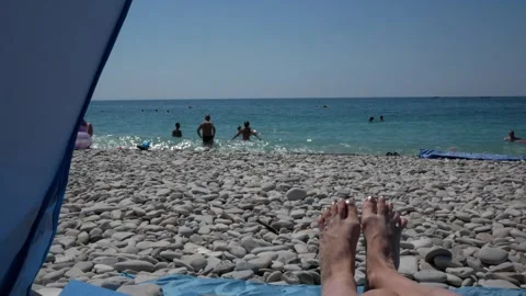 Open tent with a view of the beach. Camping and blue sea view of with pebbles. W Stock Footage 283572417