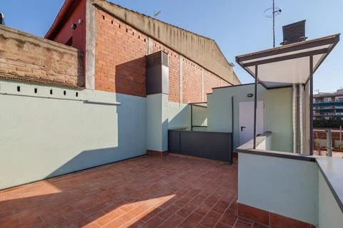 Open terrace on second floor with red brick floor. Part of terrace with fence of 스톡 사진