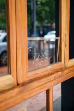 Open text on glass window of side walk cafe Stock Photos