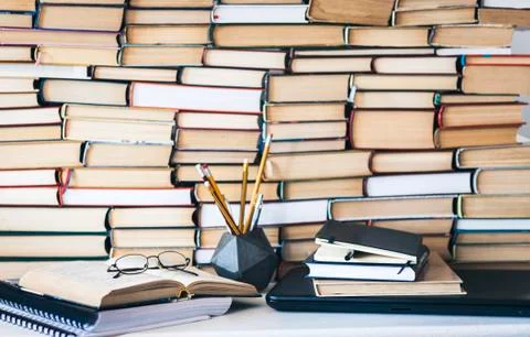 Open textbook, notebook, laptop computer, stack of books education back to sc Stock Photos