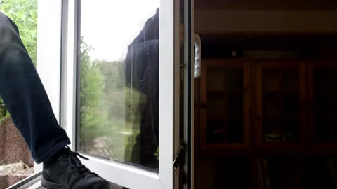 Open tilted window from inside, with a view of green outside a living room Vídeo Stock 341524459