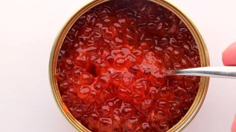 Open tin can with red caviar on a white background. Stock Footage 237226581