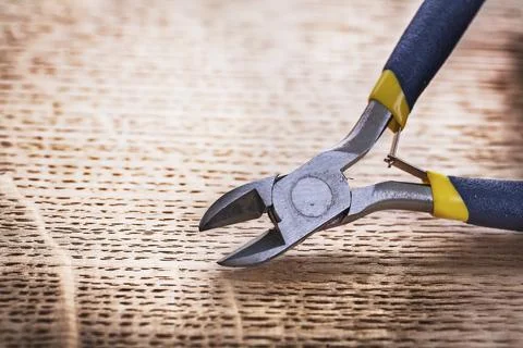 Open tongs with dark blue rubber handles on wooden board construction Concept Photos