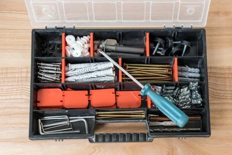 Open toolbox with different instruments. Screws and screwdriver Plactic box w Stock Photos
