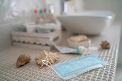 Open toothpaste and a medical protective mask lie on the table Stock Photos