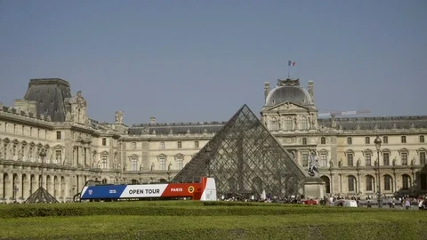 Open tour bus driving around traffic circle outside Louvre museum Paris France Stock Footage 94062709