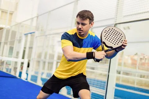 Open Tour template. Dynamic Padel Player in Action. Stock Photos