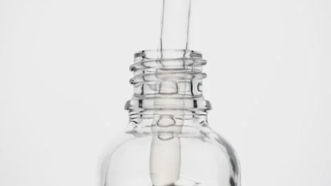 An open transparent jar with essential oil on a white background. Natural serum Stock Footage 143058809