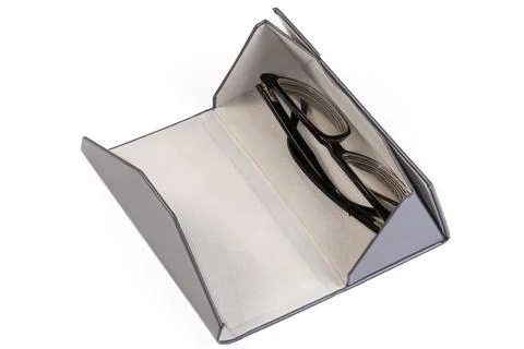Open triangular gray hard spectacle case with classic eyeglass inside 库存照片
