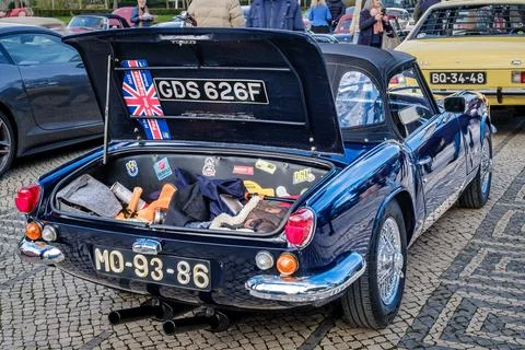 Open trunk and rear side of Triumph Spitfire MK3 on cobblestone road Stock Photos