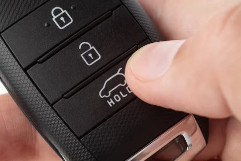 Open the trunk of a car with button on the keychain. Stock Photos