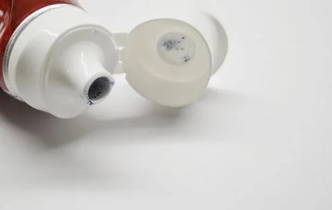 Open tube of toothpaste on white background Stock Photos