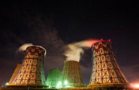Open-type cooling towers of CHP combined heat and power station in the night Stock Photos