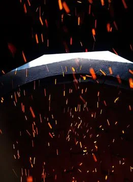 Open umbrella with falling rain and glowing sparks at night Fotos Stock