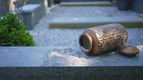 An open urn for ashes in the cemetery with a handful of ashes ,subject shooting Stock Footage 246745702