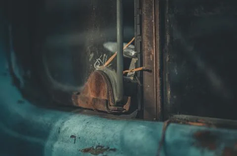 An open ventilation window in the windshield of the cab of an old truck. Rust Stock Photos