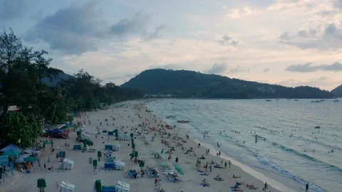 Open view  of tropical beach with numerous tourists in the beach and Stock Footage 128176559