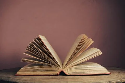 Open vintage ancient book. Pattern background for design. The book on a round Stock Photos