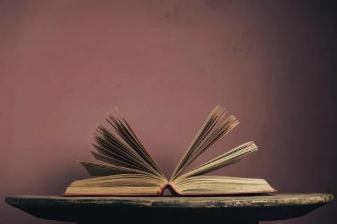Open vintage ancient book. Pattern background for design. The book on a round 写真素材