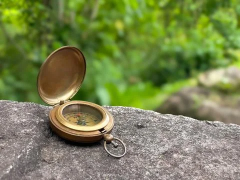 Open vintage compass on stone with copyspace Stock Photos