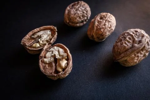 Open walnuts, and three small walnuts. 스톡 사진