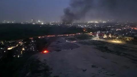 Open waste burning producing thick black smoke near residential Stock Footage 340037585