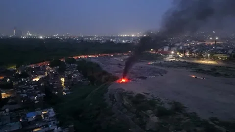 Open waste burning producing thick black smoke near residential Stock Footage 340037613