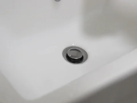 Open Water flows into drain in sink Stock Footage 125802414