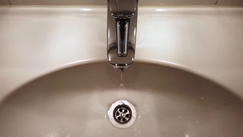 Open water tap in a bathroom Stock Footage 123899481