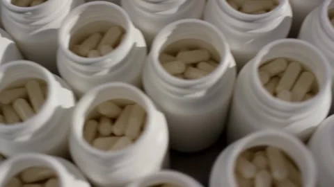 Open White Bottles Filled With Pale Capsules, Pharmaceutical Line, Close Up Stock Footage 341331671