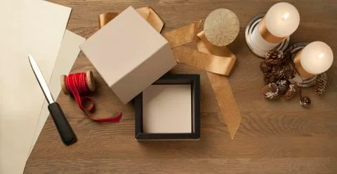 Open white christmas gift box waiting to be packed over a rustic table Stock Photos