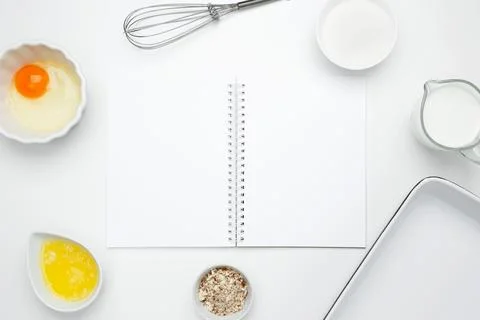 Open white notebook with baking ingredients for Crinkle Cake, including butte Stock Photos